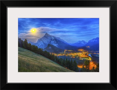 Supermoon rising over Mount Rundle and Banff townsite in Canada