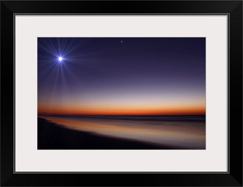 Big photo on canvas of a bright moon and Venus in the dusk sky above an ocean.