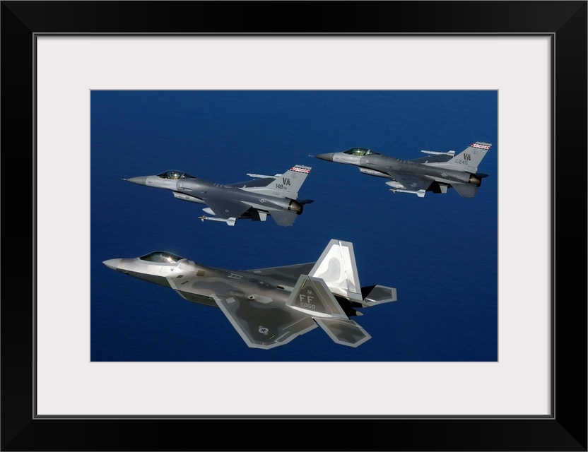 Three F-22A Raptor aircrafts fly in formation.
