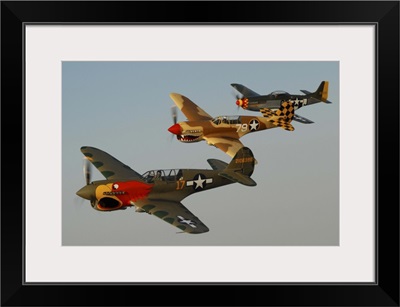 Two P-40 Warhawks and a P-51D Mustang flying over Chino, California