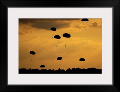 U.S. Army Soldiers parachute through the sky