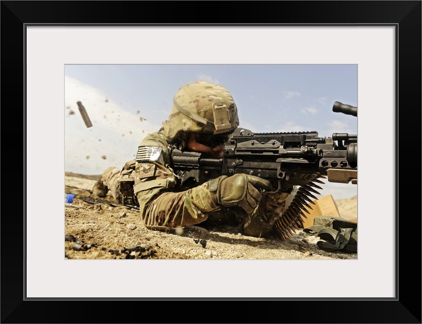 U.S. Air Force soldier fires the Mk48 super SAW machine gun at the off-base firing range near forward operating base Mehta...