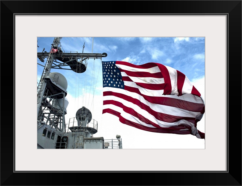 Pacific Ocean, September 20, 2012 - The Ticonderoga-class guided-missile cruiser USS Cowpens (CG 63) flies a large America...