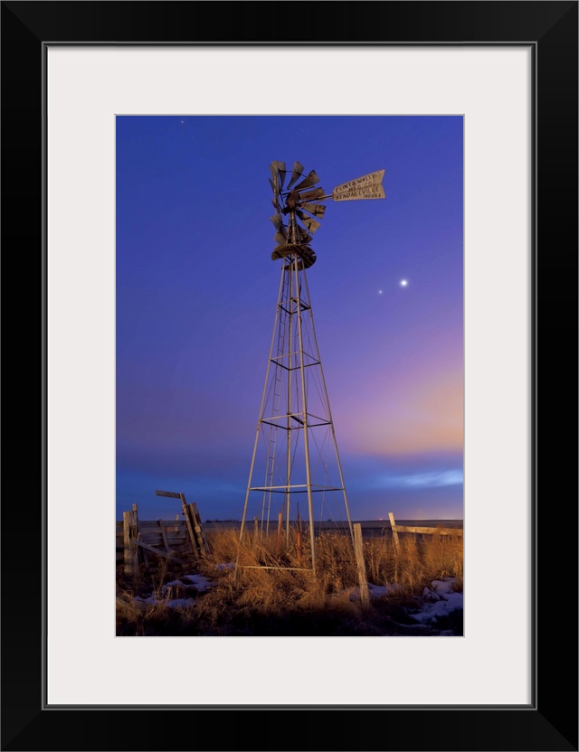 March 12, 2012 - Venus and Jupiter are visible behind an old farm water pump windmill on Glenmore Trail east of Langdon, A...