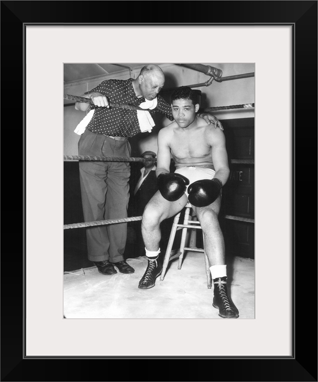 American heavyweight pugilist. In training camp at Pompton Lakes, New York, 4 June 1938, with his trainer Jack Blackburn.