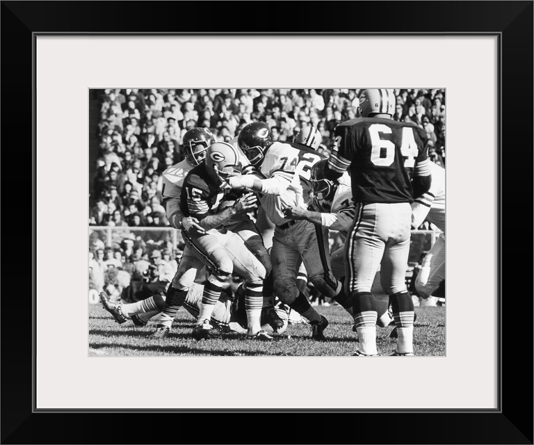 Quarterback Bart Starr of the Green Bay Packers being sacked for an 11-yard loss by Dick Butkus and Bob Kilcullen (74) of ...