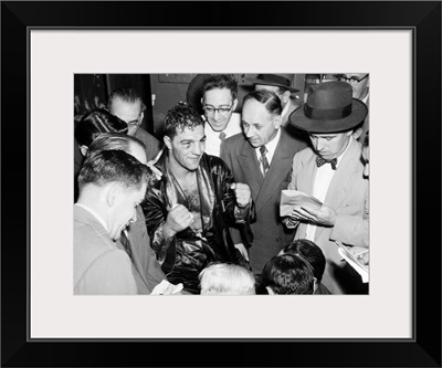 Rocky Marciano, with reporters after his victory against Joe Louis
