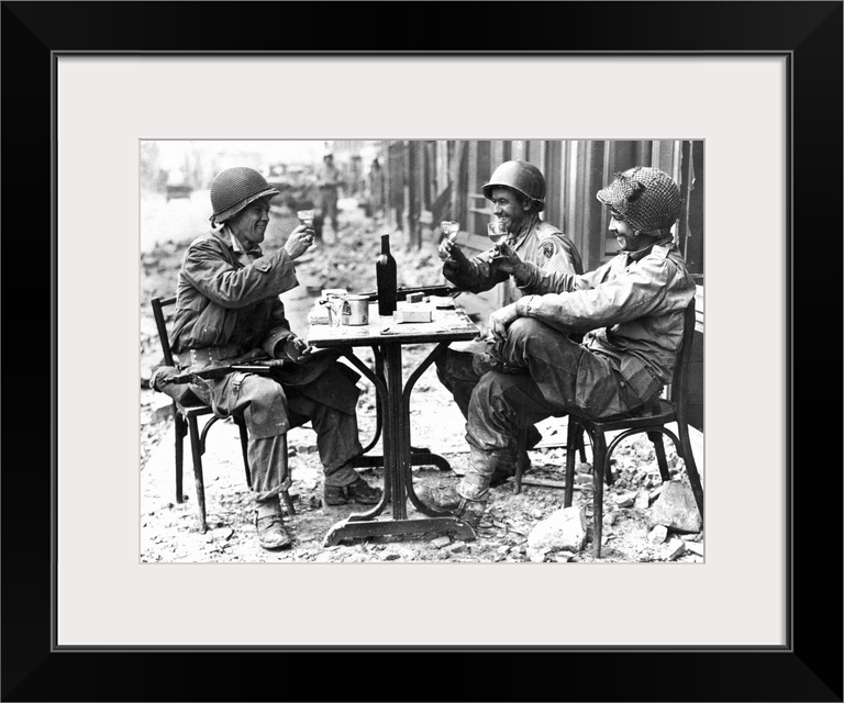 Three American soldiers at a sidewalk cafe in Paris, France, following the Allied liberation of the city, August 1944.