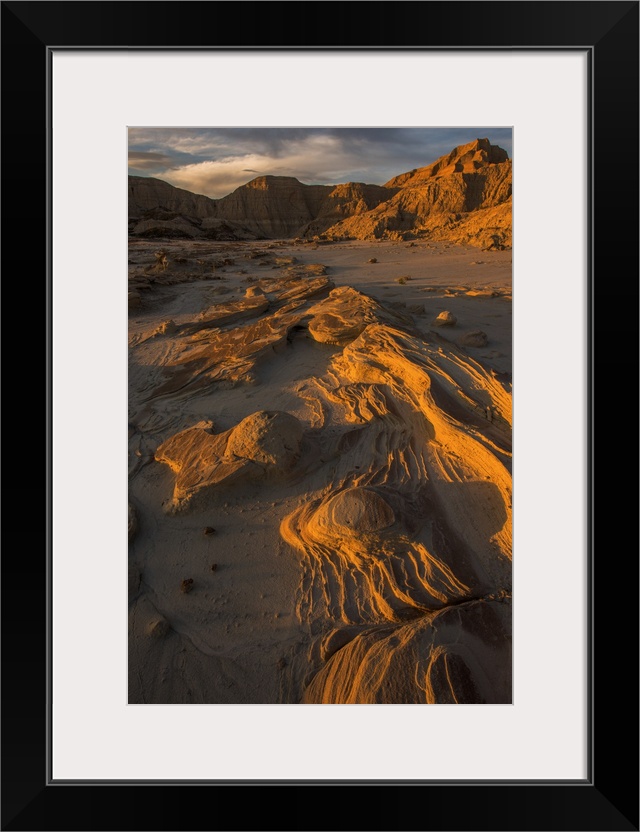 Eroded rocks in the South Dakota Badlands in warm light from the sunset.