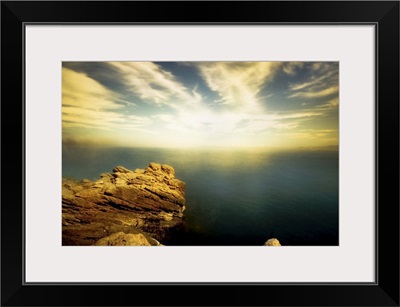 A rocky shore with calm water