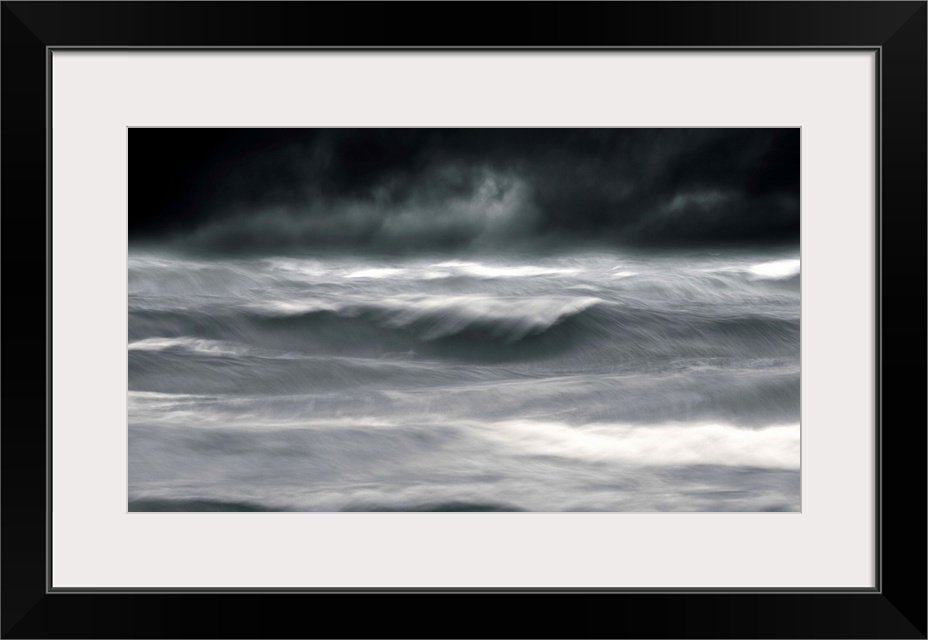 Powerful waves in a seascape under a dark stormy sky