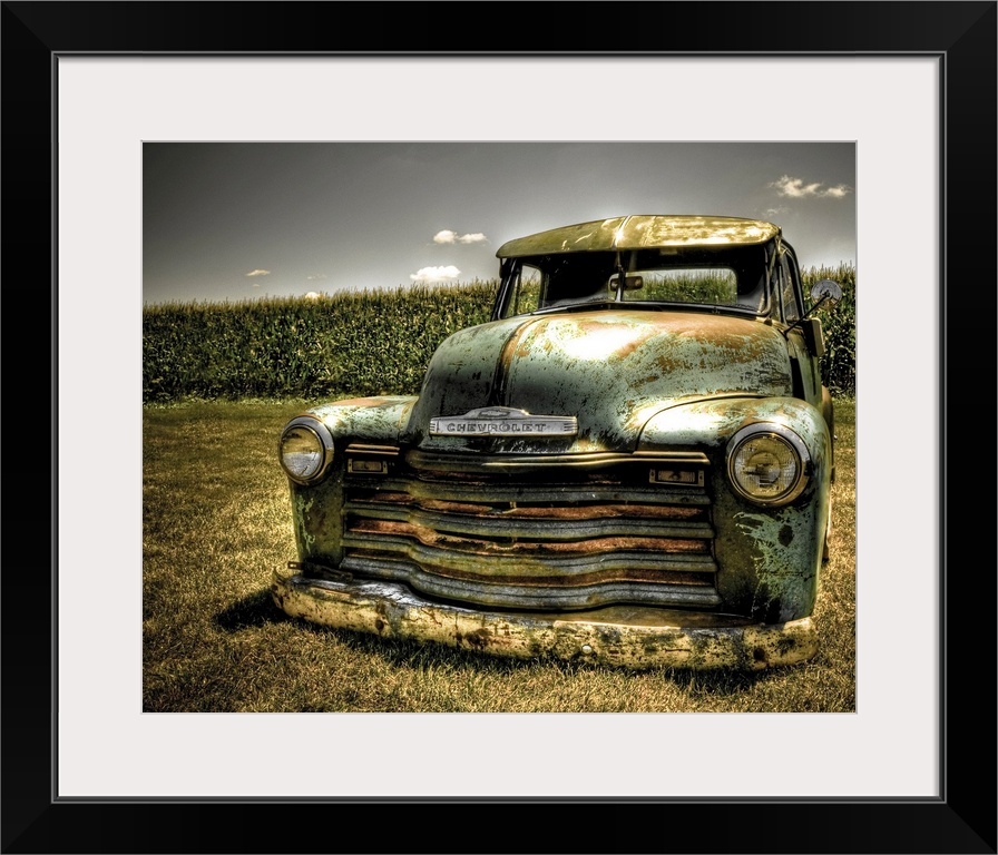 A photo on canvas of a vintage Chevrolet truck parked in front of a corn field.