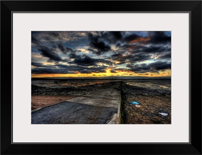 Cloudy evening sunset over an estuary with dramatic stormy clouds