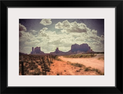 Large monolithic rocks in the background looking through Monument Valley III