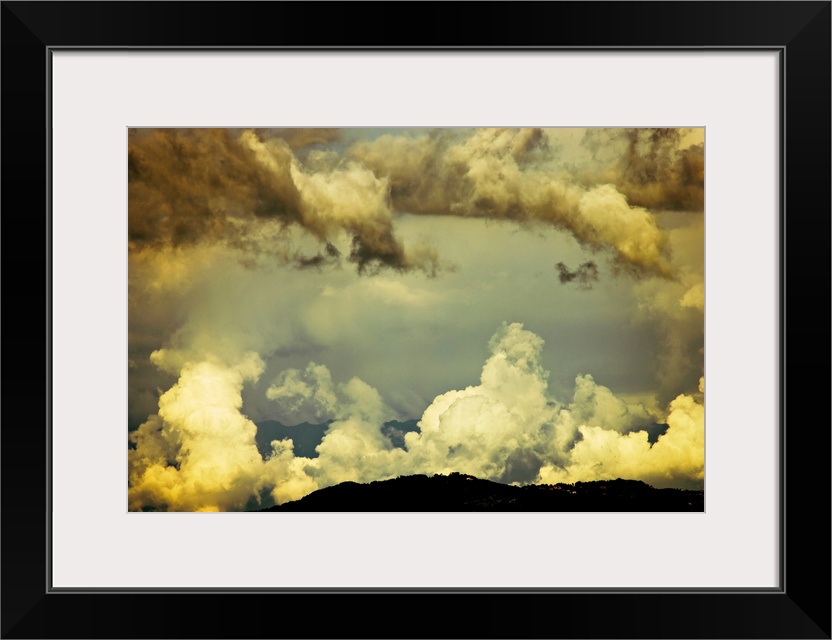 Scattered monsoon clouds above hills