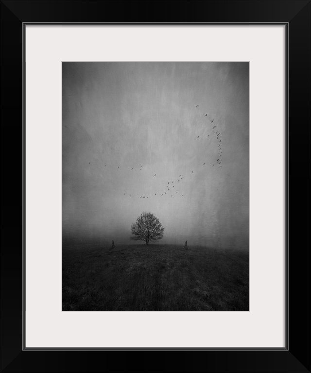 Silhouettes of two persons walking away from each other and a lonely tree in a strange and further empty landscape