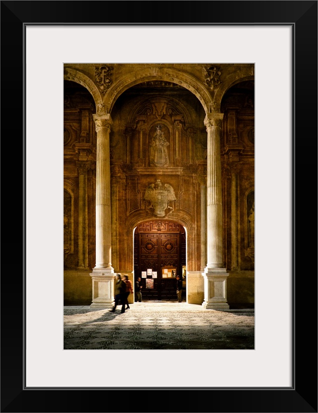 Some people at the entrance of the Santo Domingo Church in Granada, Spain
