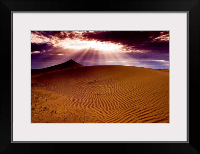 Sunlight shining on sand dunes