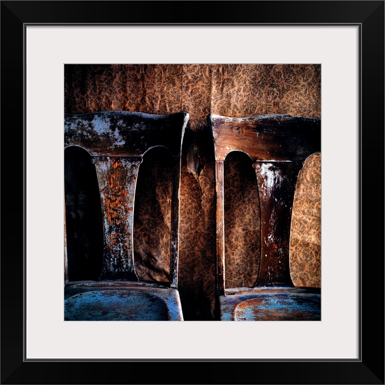 Two old chairs against a wall