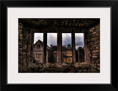 View through a stone window of ruined castle