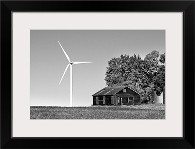 Wind turbine in rural location with old barn in Cavalier County, USA