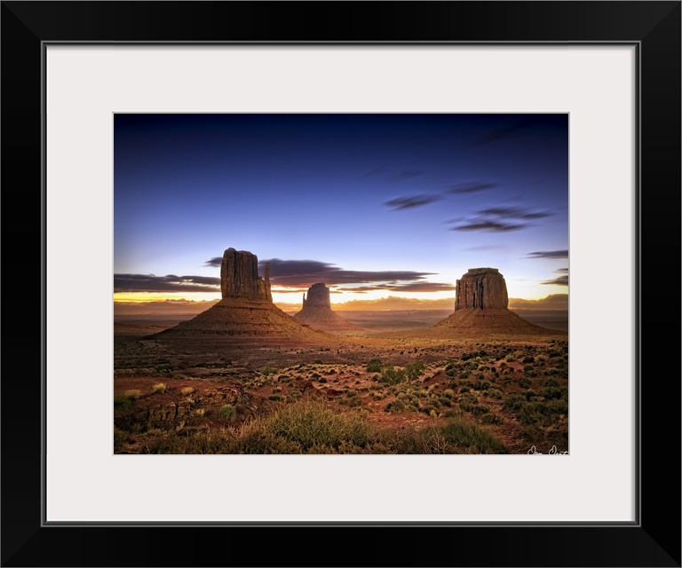 Beautiful photograph of the canyons in Monument Valley, AZ at sunset.