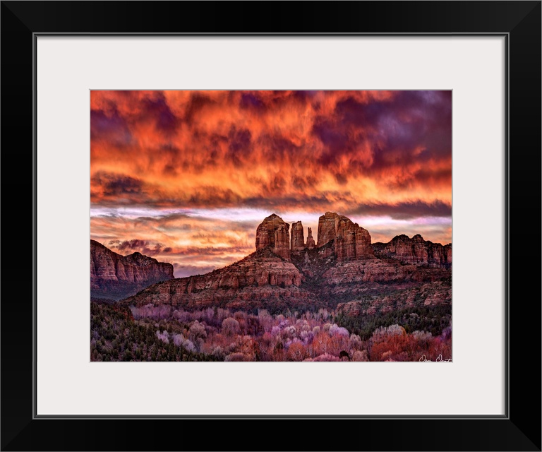 High definition photograph of sandstone canyons with a fire sky above.