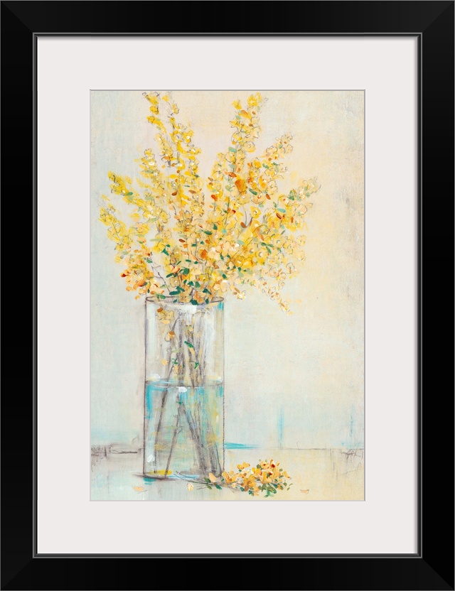 Yellow flowers sitting in a rectangular glass vase.