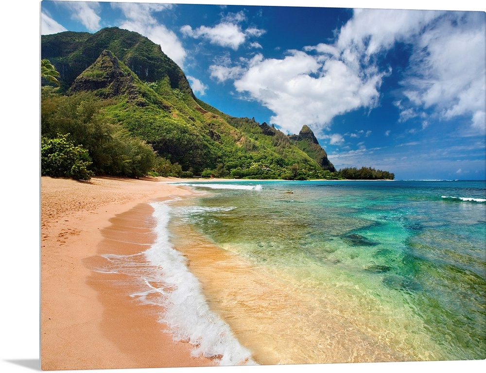 Big photograph shows the clear waters of the Pacific Ocean slowly making their way to the sandy shores of an island.  In t...