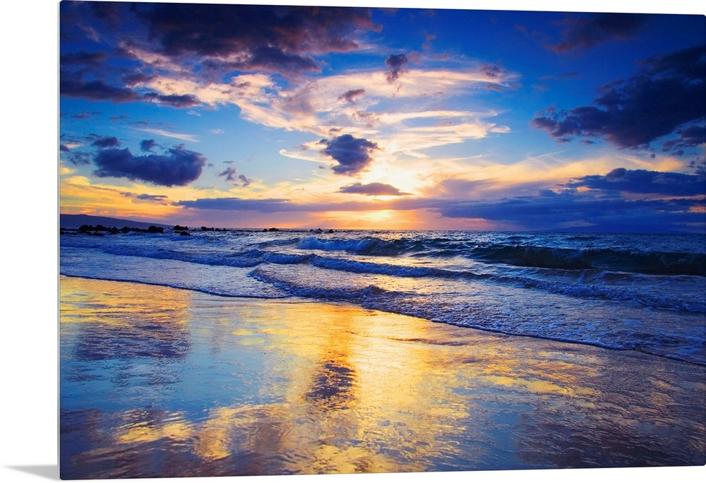 Horizontal photograph on a large wall hanging of a vivid sunset glowing through clouds, over the shore of Mokapu Beach in ...