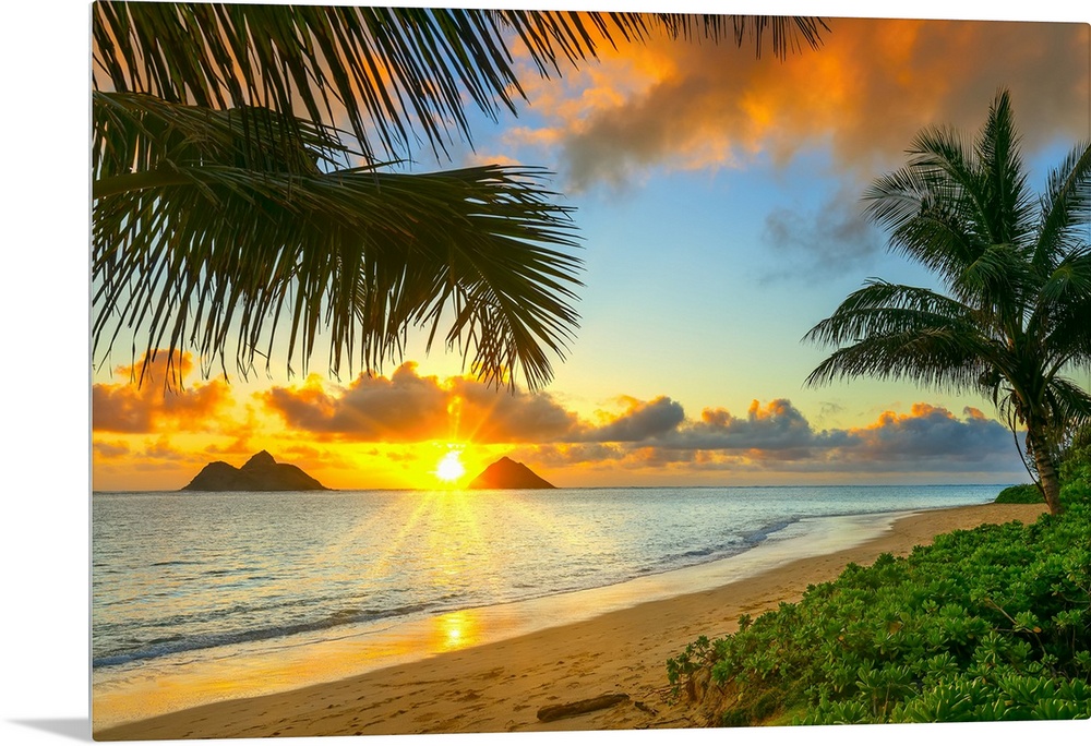 Sunrise viewed from Lanikai Beach with a view of the Mokulua Islands off the coast; Oahu, Hawaii, United States of America.