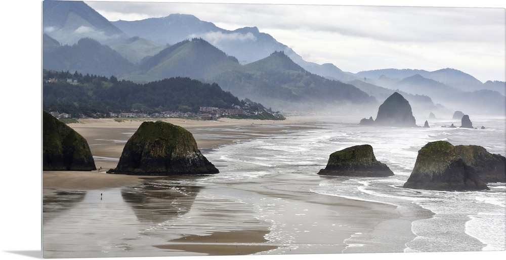 USA, Oregon, Cannon Beach. Fog rises over coastline at low tide.