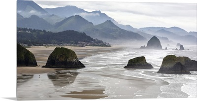 Oregon, Cannon Beach. Fog rises over coastline at low tide