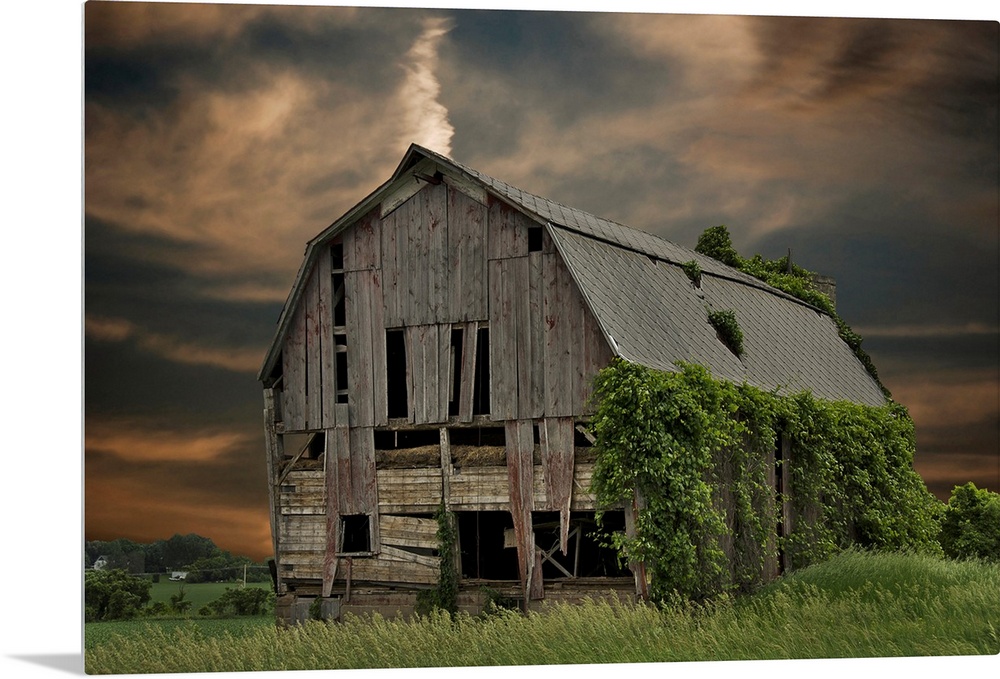 Dilapidated old barn with sunset sky.