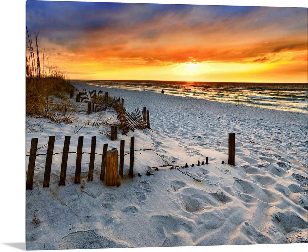 A sandy beach before a bright red sunset on the beach. The sand in This part of Florida is bright white. Landscape taken o...