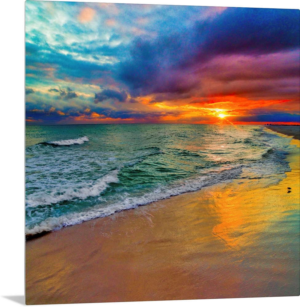A square image of the sun descending over the ocean amid bright, technicolor clouds.