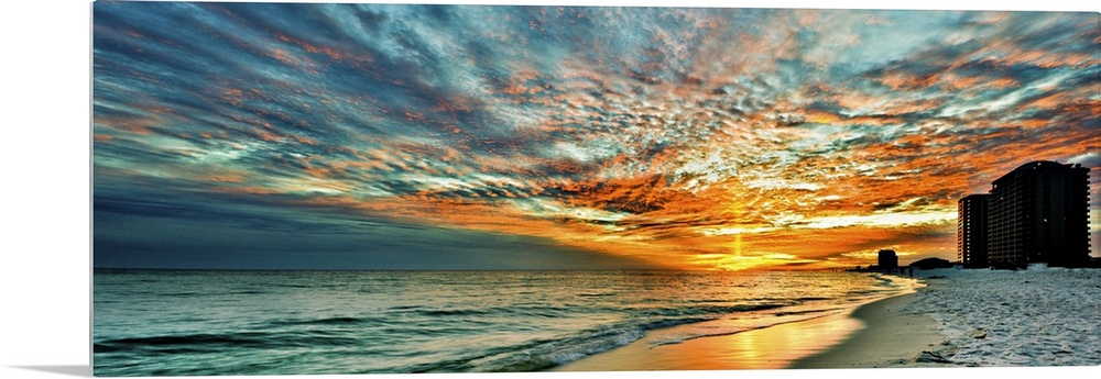 A magnificent red skyscape in this panoramic sunset. Landscape taken on Navarre Beach, Florida.