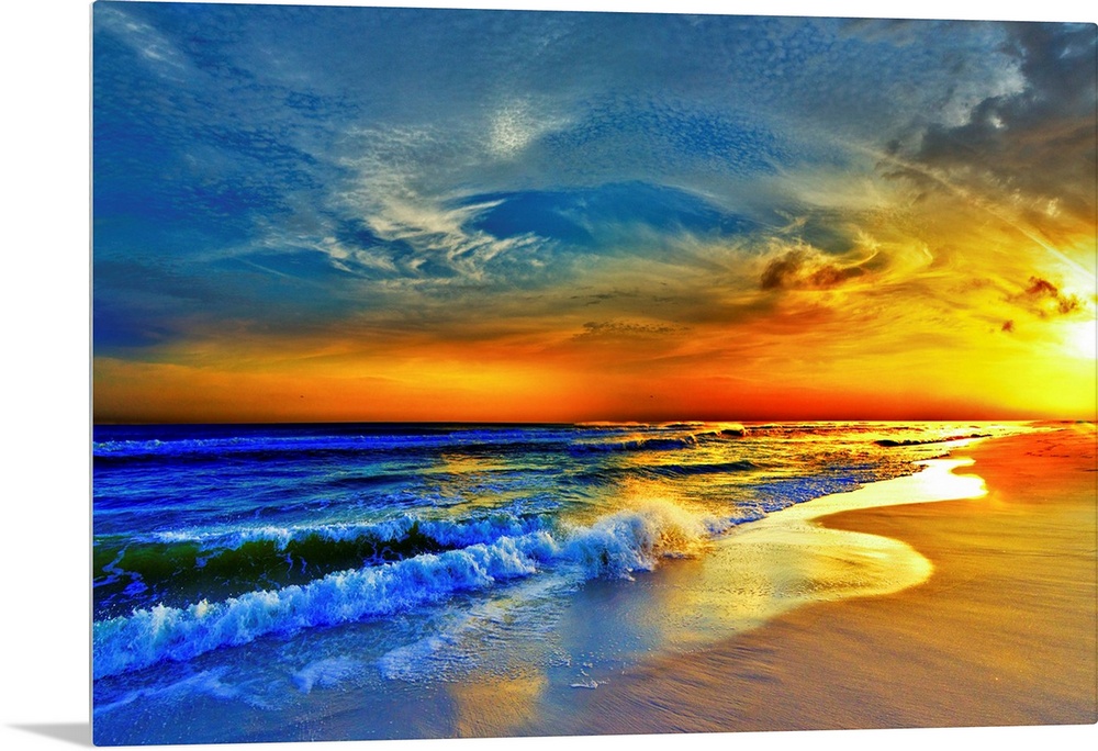 A sandy beach before a bright burning red sunset.  Waves crash onto the sandy sea shore. Landscape taken on Navarre Beach,...