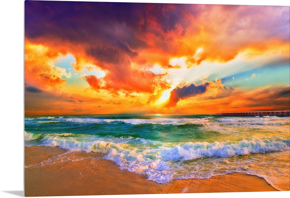 A red, orange and purple sunset on the beach. Beautiful ocean waves roll onto the sea shore.