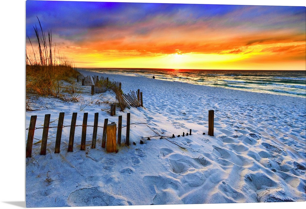A dark burning red sunset on the beach in this beautiful landscape. A burning sun sets in the distant sea beyond a sandy s...