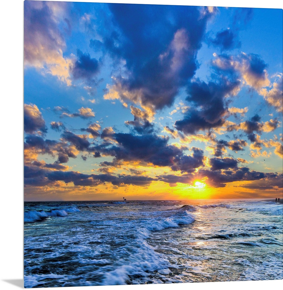 A Florida sunset with expanding puffy blue clouds during winter.