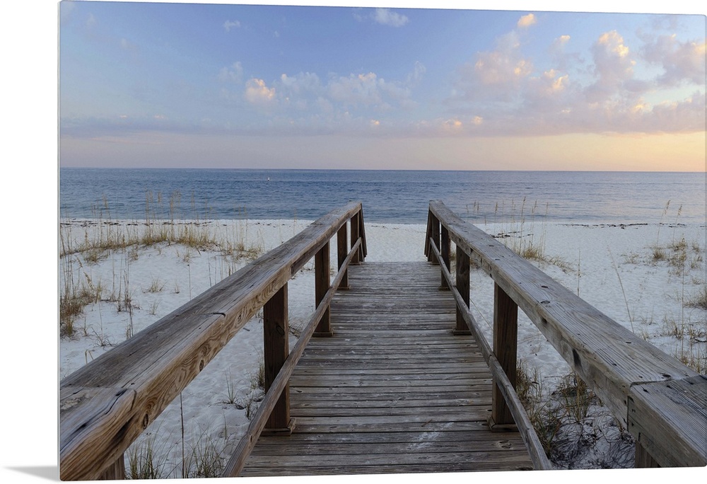 Photograph of a wooden walkway leading to the sandy beach with a Pensacola sunset