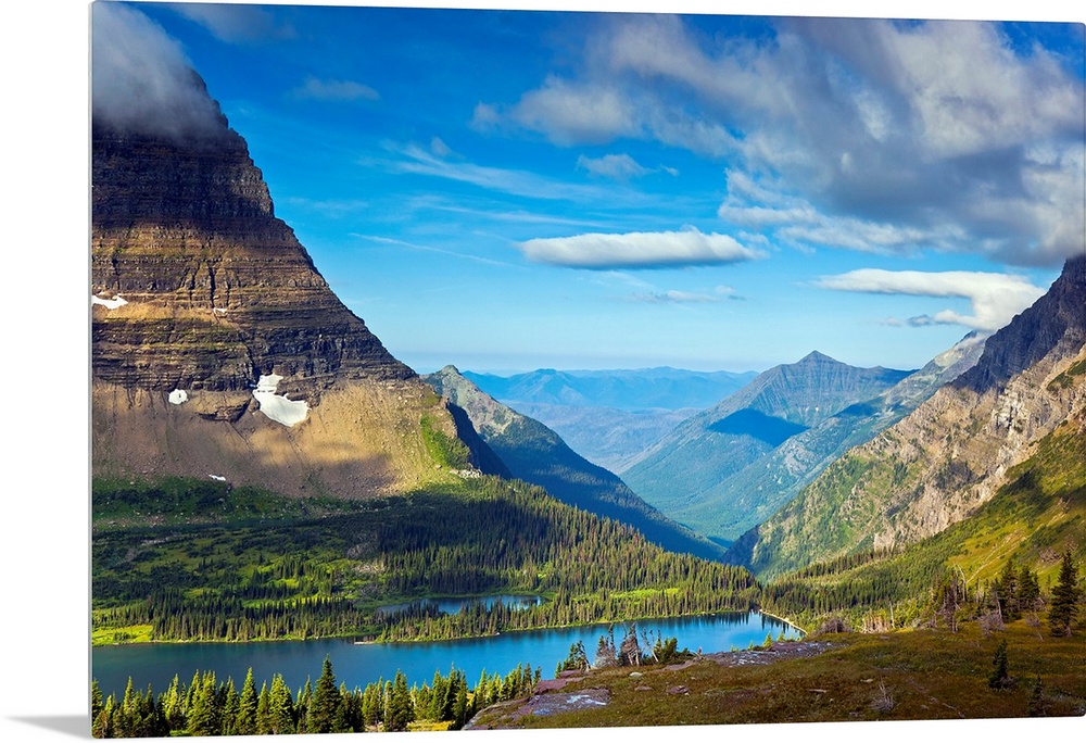 Large, landscape photograph of  Hidden Lake from an overlook, surrounded by mountains in Glacier National Park.