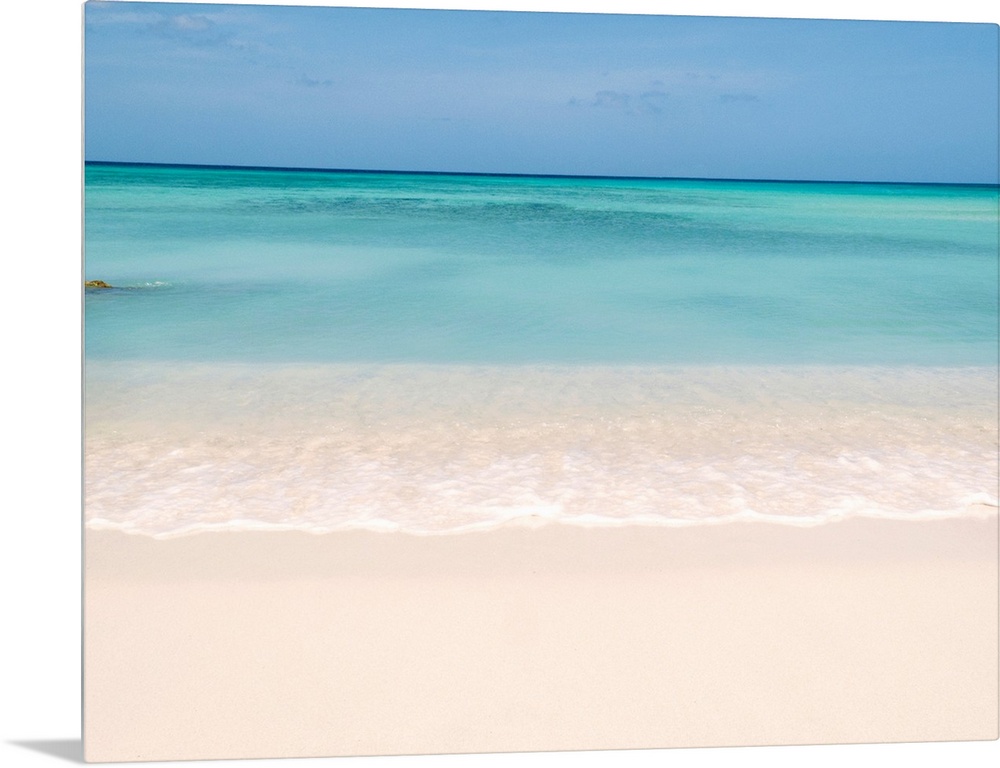 Horiztonal wall art of a serene beach and a still sea on a clear day in Aruba.