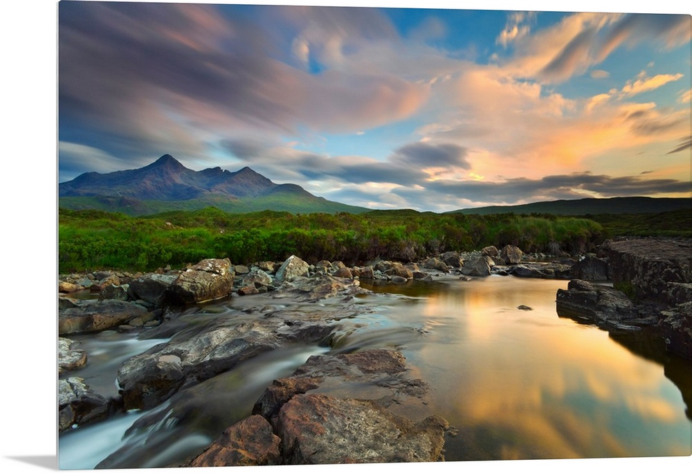 Isle of Skye, Scotland, Europe. The last sunset colors reflected in the water. In the background the peaks of the Black Cu...