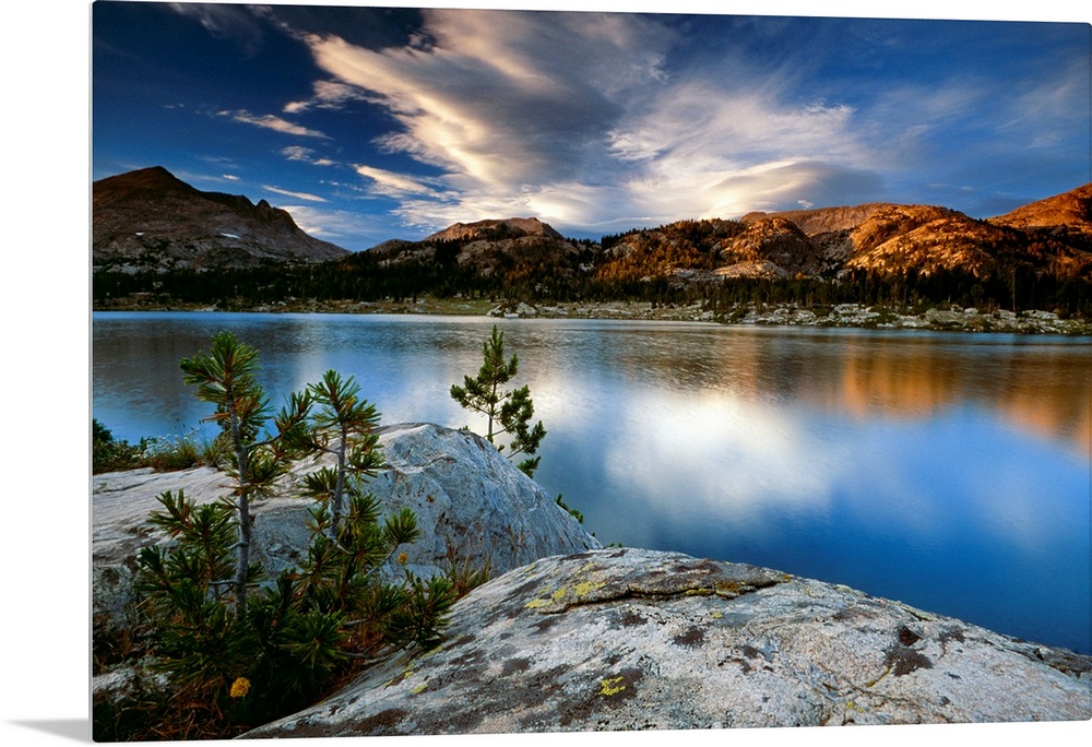 Clouds and mountains reflect in the surface of the still water in this oversized art for the decoration.