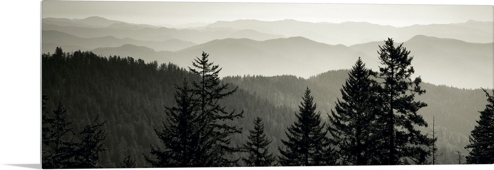 Panoramic monochromatic photograph displays a view overlooking the layered mountain ranges within a region of the Southeas...