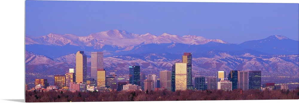 Panoramic view of the Rocky Mountains and downtown skyline of the Mile High City, Colorado in the early morning.