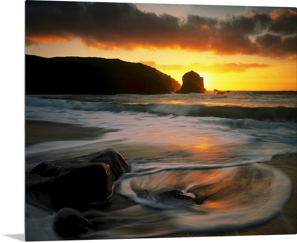 Beautiful time lapsed photography wall art of waves on the beach at sunset.