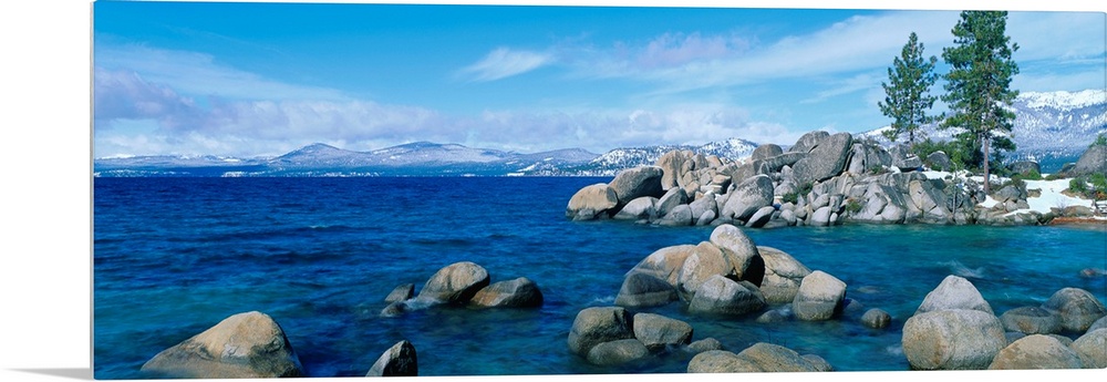 A panoramic photograph taken at eye level this home wall art shows the boulder covered shores of this world renowned lake.
